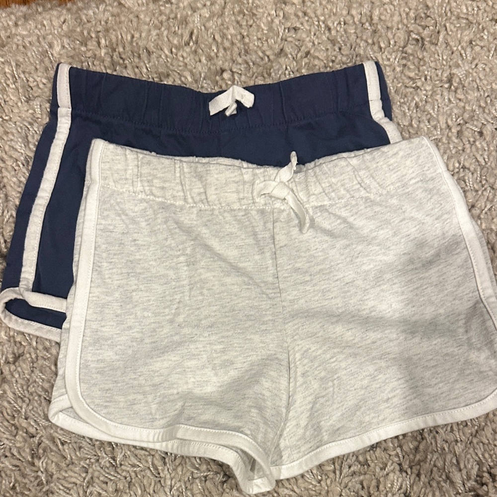 Two Osh Kosh dolphin shorts in 5T. Navy and light grey. Light grey never worn